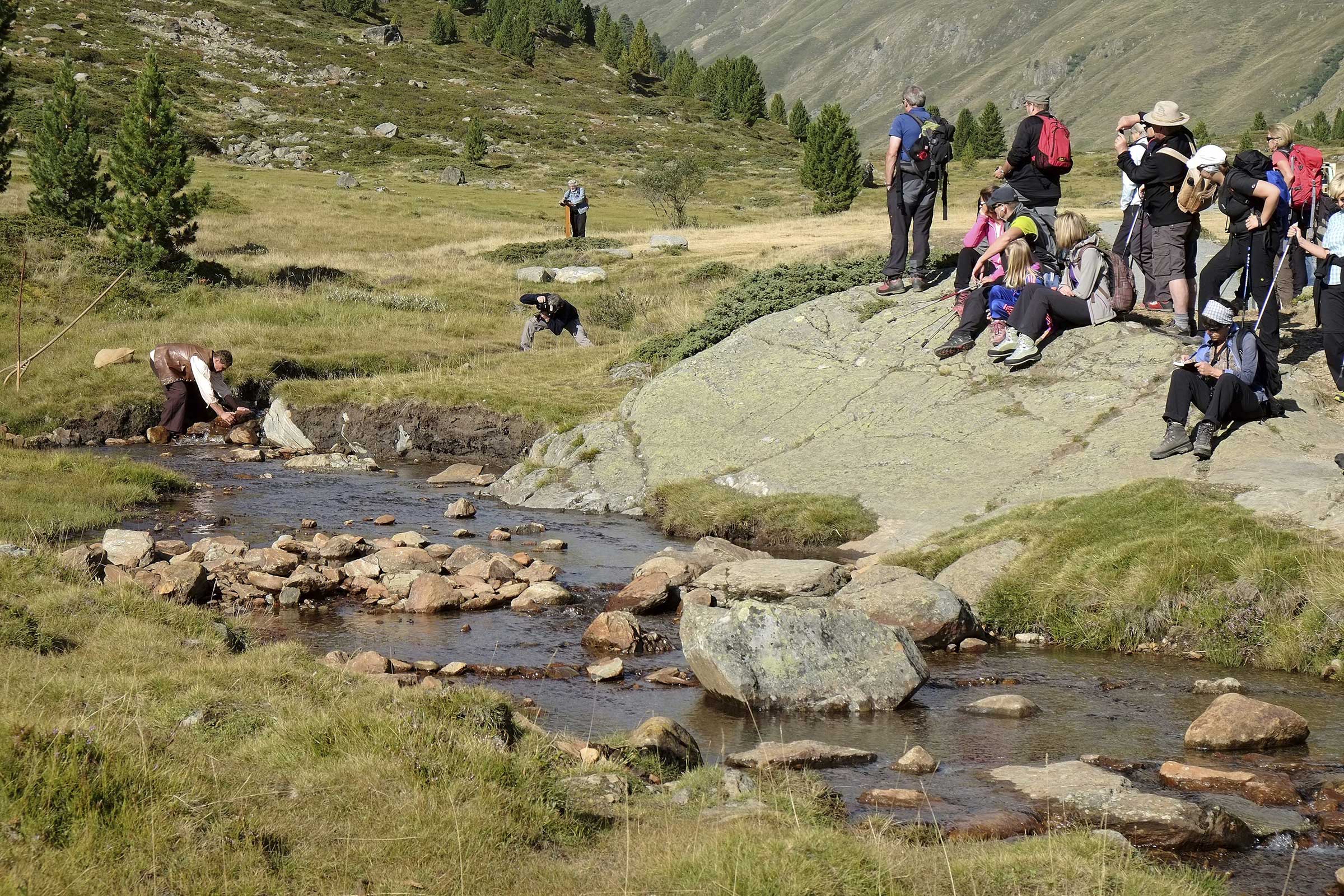 Schauspieler und Zuschauer am Bach - Wandertheater Friedl mit der leeren Tasche